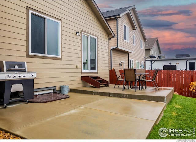 6659 12th St, Frederick, CO 80530 - back of property with a patio area, fence, and outdoor dining space