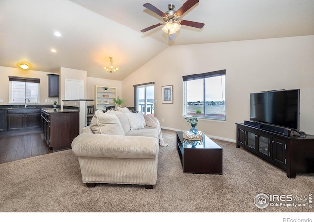 6659 12th St, Frederick, CO 80530 - living area featuring ceiling fan with notable chandelier, plenty of natural light, vaulted ceiling, and dark carpet