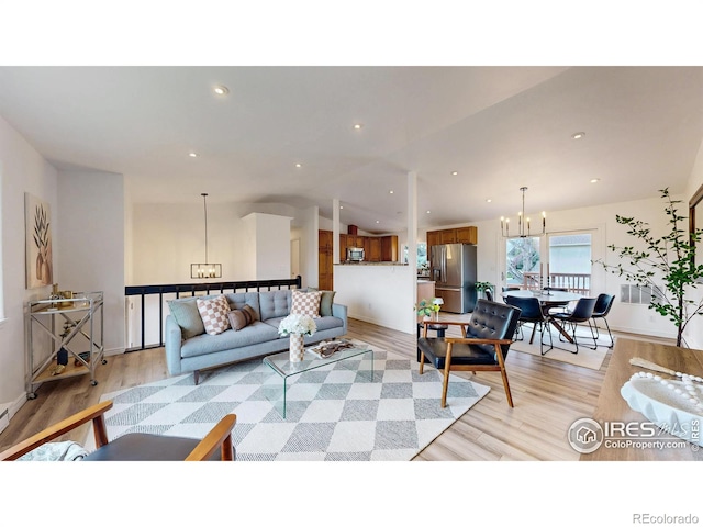 living area featuring an inviting chandelier, recessed lighting, and light wood-type flooring
