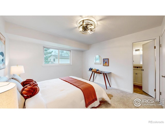 carpeted bedroom featuring baseboards