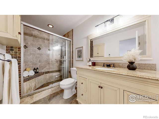 full bath featuring vanity, recessed lighting, a stall shower, and toilet