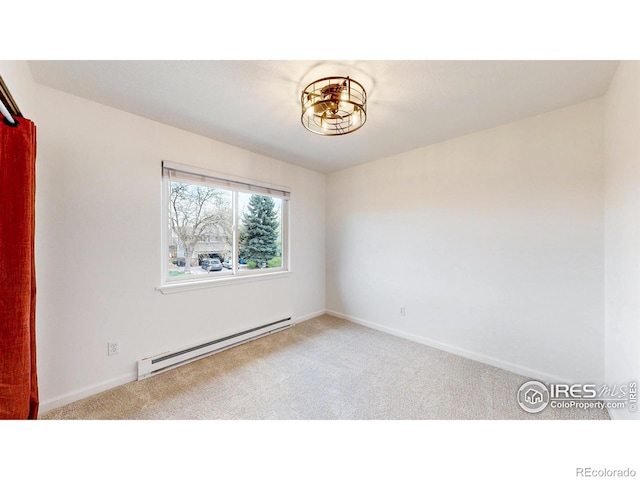 carpeted empty room with baseboards and a baseboard heating unit
