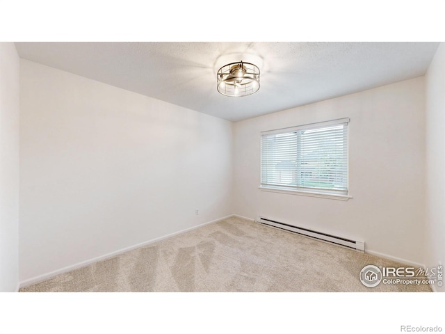 empty room featuring carpet floors, baseboards, and baseboard heating