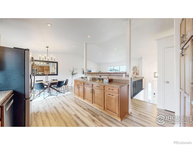 kitchen with light wood-type flooring, lofted ceiling, a chandelier, and stainless steel appliances