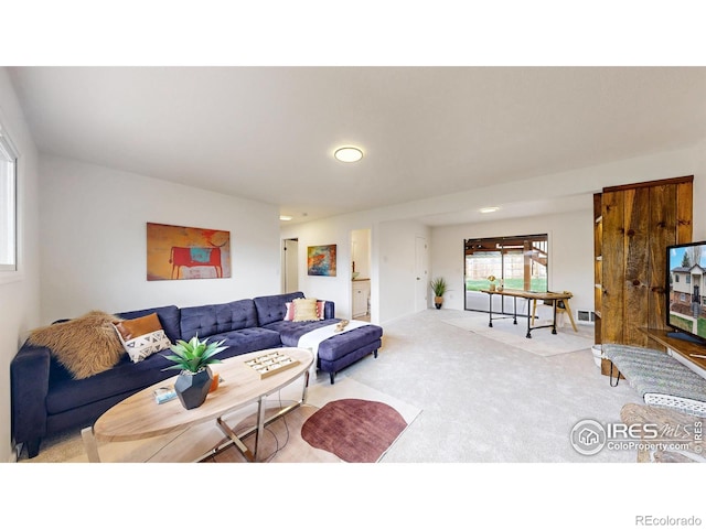 living area featuring recessed lighting, carpet flooring, and visible vents