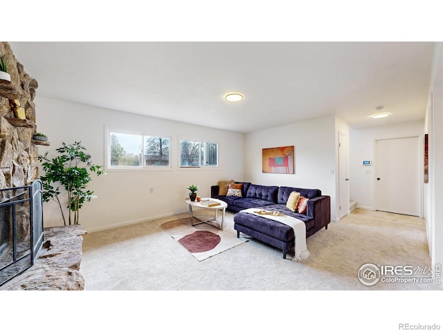 living room with light colored carpet, recessed lighting, baseboards, and a fireplace