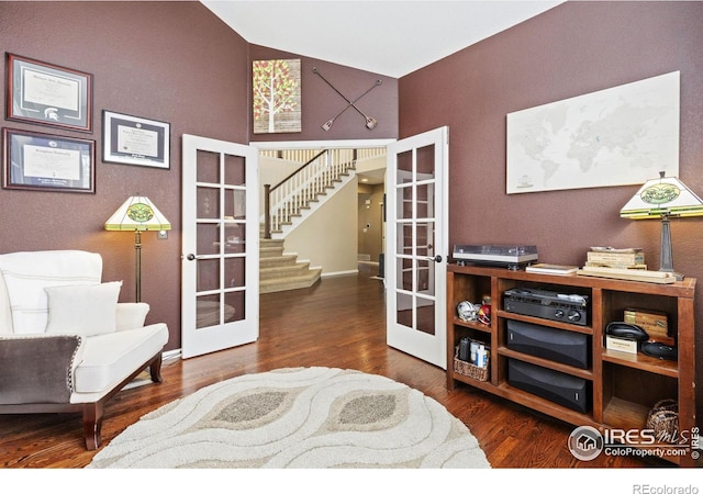 sitting room with french doors, baseboards, stairs, and wood finished floors