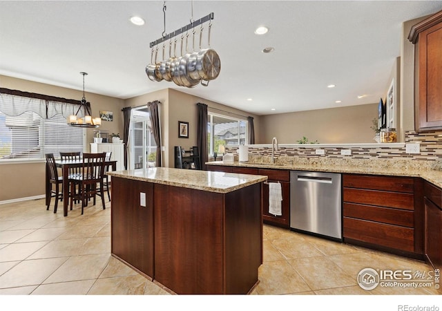 kitchen featuring a sink, light tile patterned floors, a center island, and dishwasher