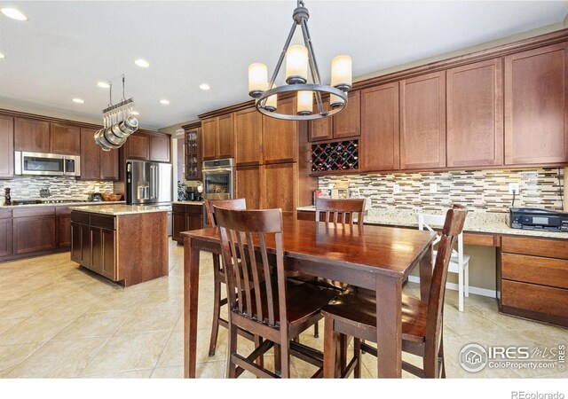 dining area with recessed lighting, a notable chandelier, and light tile patterned floors