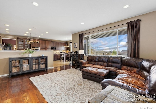 living area with recessed lighting and dark wood-style floors