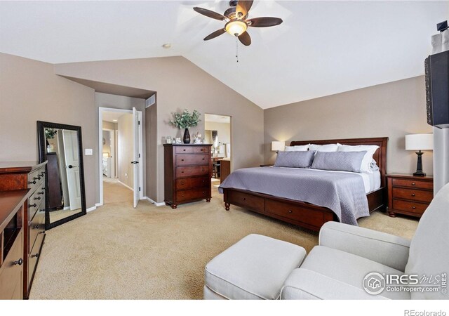 bedroom with connected bathroom, light carpet, a ceiling fan, baseboards, and lofted ceiling
