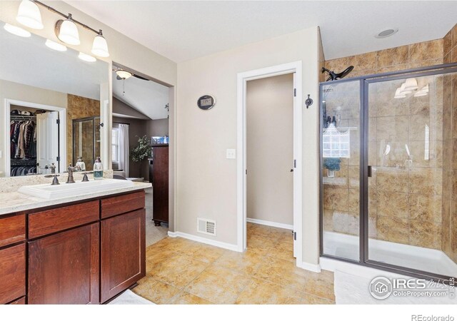 full bath featuring visible vents, a shower stall, vanity, tile patterned floors, and a spacious closet