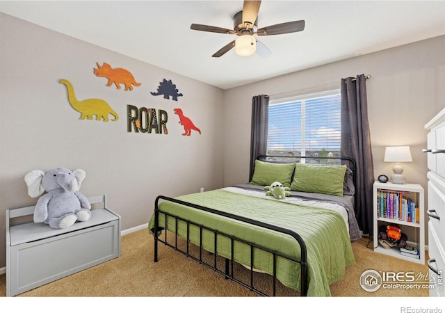 carpeted bedroom with a ceiling fan and baseboards
