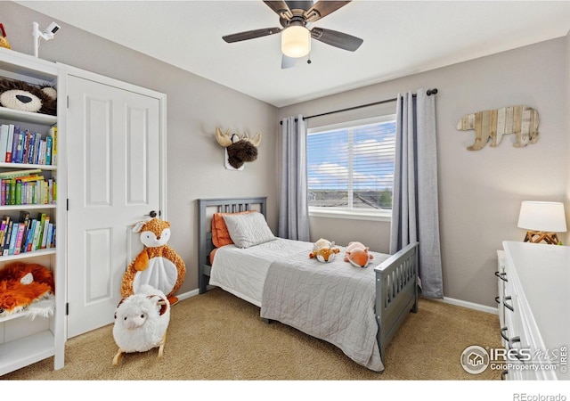 bedroom featuring baseboards, ceiling fan, and light colored carpet