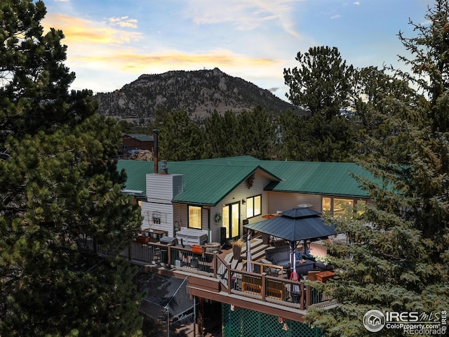 2505 Longview Dr, Estes Park, CO 80517 - rear view of house featuring a gazebo, a deck with mountain view, metal roof, and a chimney