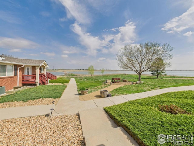 5425 County Road 32 Unit 15, Mead, CO 80504 - view of grassy yard featuring a water view and central air condition unit