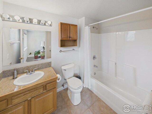 5425 County Road 32 Unit 15, Mead, CO 80504 - bathroom with toilet, tile patterned flooring, vanity, shower / bath combo with shower curtain, and baseboards