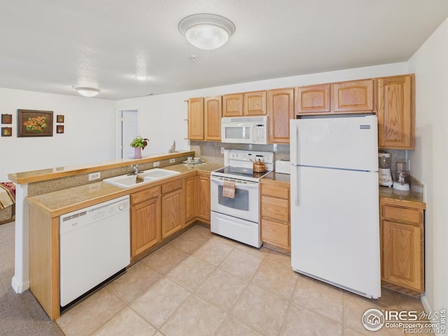 5425 County Road 32 Unit 15, Mead, CO 80504 - kitchen with white appliances, a sink, a peninsula, light tile patterned floors, and light countertops