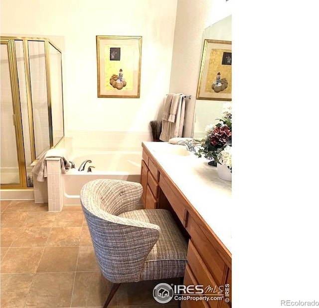 13873 Legend Way Unit 103, Broomfield, CO 80023 - full bathroom featuring vanity, a garden tub, a shower stall, and tile patterned flooring