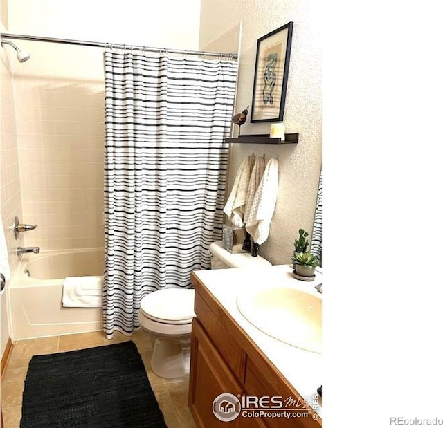 13873 Legend Way Unit 103, Broomfield, CO 80023 - bathroom with toilet, shower / bathtub combination with curtain, vanity, tile patterned flooring, and a textured wall