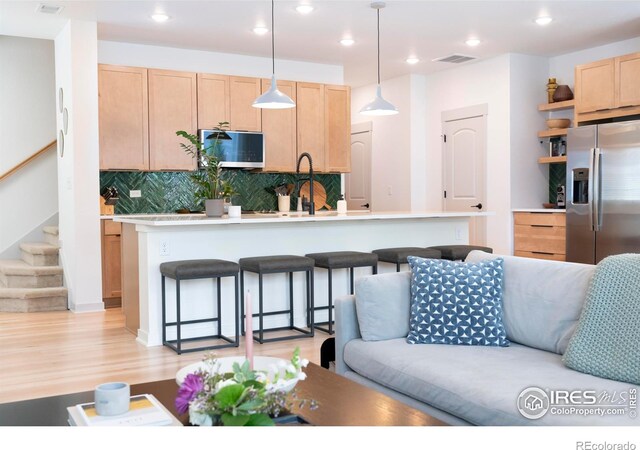 4424 Haymill Ct, Timnath, CO 80547 - living area with stairs, light wood-style flooring, and recessed lighting