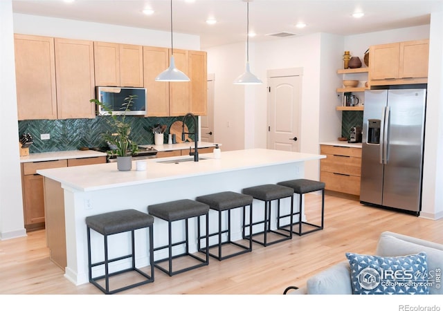 4424 Haymill Ct, Timnath, CO 80547 - kitchen featuring appliances with stainless steel finishes, open shelves, light wood-type flooring, a sink, and tasteful backsplash