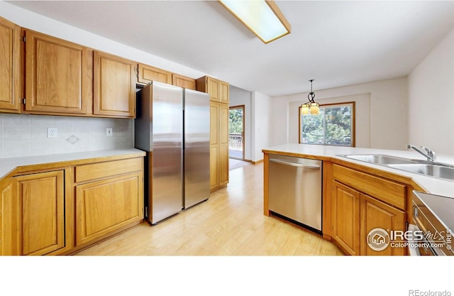 711 Eagle Ln, Estes Park, CO 80517 - kitchen with brown cabinets, stainless steel appliances, a sink, and light wood-style floors