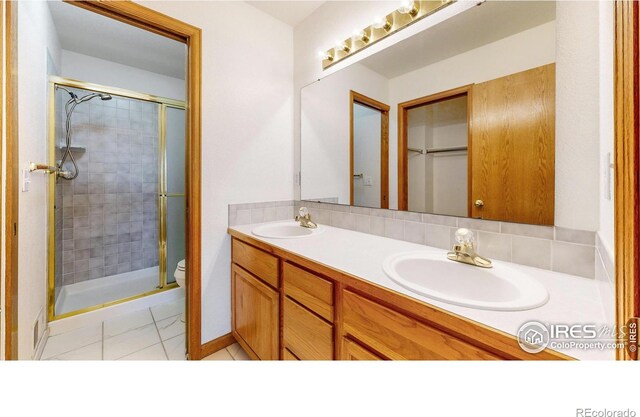 711 Eagle Ln, Estes Park, CO 80517 - bathroom featuring double vanity, a sink, a stall shower, and tile patterned floors