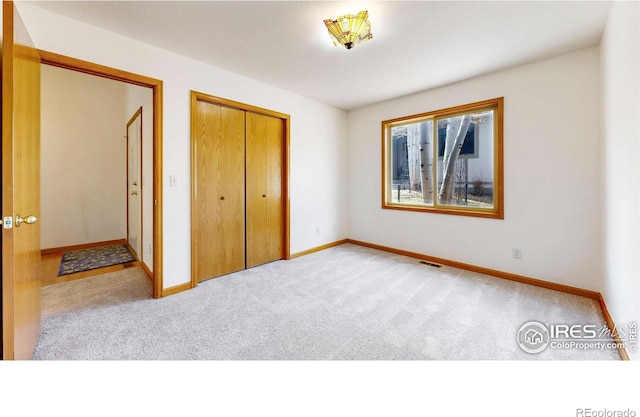 711 Eagle Ln, Estes Park, CO 80517 - unfurnished bedroom with baseboards, carpet flooring, and visible vents