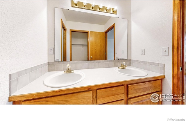 711 Eagle Ln, Estes Park, CO 80517 - full bathroom featuring a sink, a textured wall, and double vanity