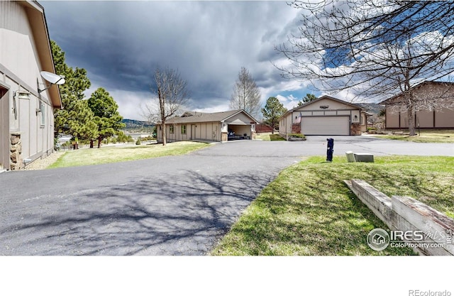 711 Eagle Ln, Estes Park, CO 80517 - view of front facade featuring a residential view, driveway, and a front yard