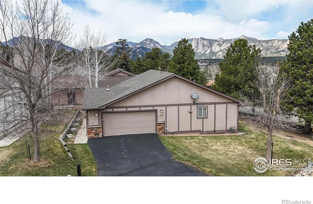 711 Eagle Ln, Estes Park, CO 80517 - view of front of house featuring roof with shingles, an attached garage, a front lawn, aphalt driveway, and a mountain view