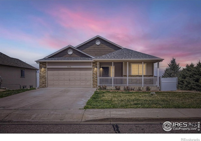 8301 W 18th Street Rd, Greeley, CO 80634 - ranch-style home featuring driveway, a porch, an attached garage, a front yard, and a shingled roof