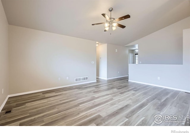 8301 W 18th Street Rd, Greeley, CO 80634 - spare room featuring a ceiling fan, vaulted ceiling, baseboards, and light wood-style floors