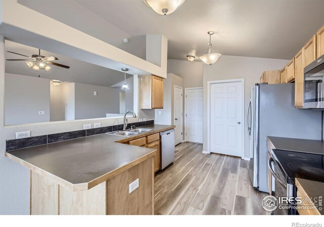 8301 W 18th Street Rd, Greeley, CO 80634 - kitchen with a sink, stainless steel appliances, light brown cabinets, a peninsula, and dark countertops