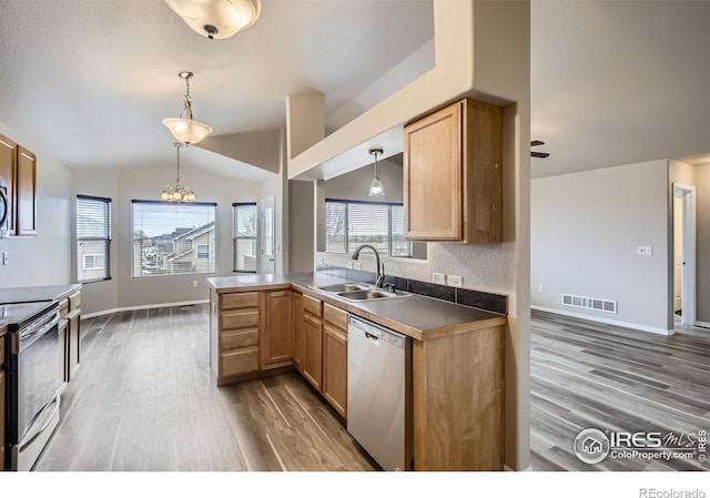 8301 W 18th Street Rd, Greeley, CO 80634 - kitchen featuring a sink, stainless steel appliances, light wood-style floors, a chandelier, and lofted ceiling