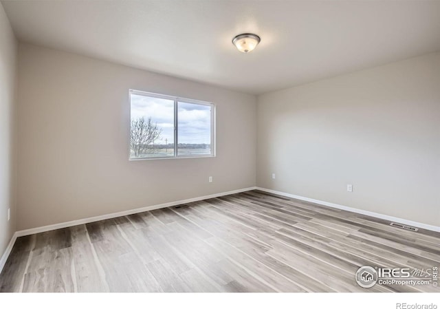 8301 W 18th Street Rd, Greeley, CO 80634 - unfurnished room with wood finished floors and baseboards