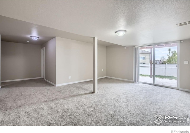 8301 W 18th Street Rd, Greeley, CO 80634 - below grade area with a textured ceiling, carpet floors, and baseboards
