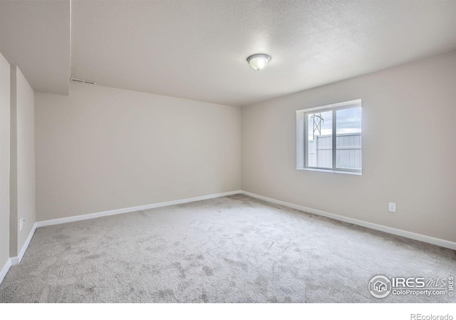 8301 W 18th Street Rd, Greeley, CO 80634 - spare room featuring carpet, baseboards, and a textured ceiling