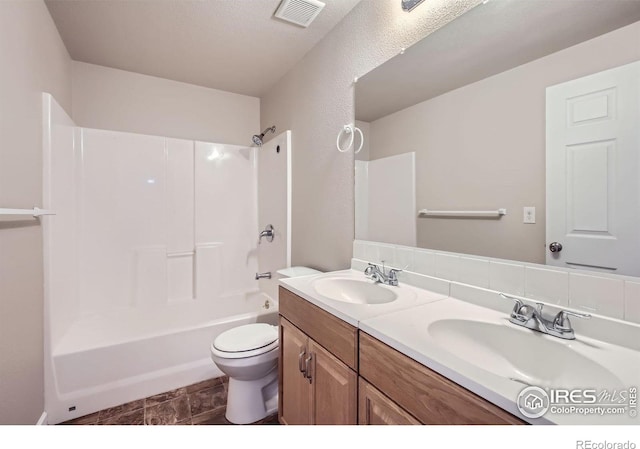 8301 W 18th Street Rd, Greeley, CO 80634 - full bathroom featuring toilet, double vanity, and washtub / shower combination