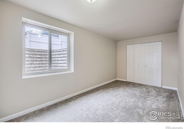 8301 W 18th Street Rd, Greeley, CO 80634 - unfurnished bedroom featuring carpet, baseboards, and a closet