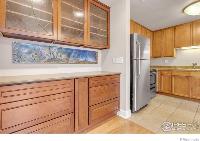4500 Baseline Rd Unit 3203, Boulder, CO 80303 - kitchen featuring glass insert cabinets, light countertops, stainless steel appliances, and a sink