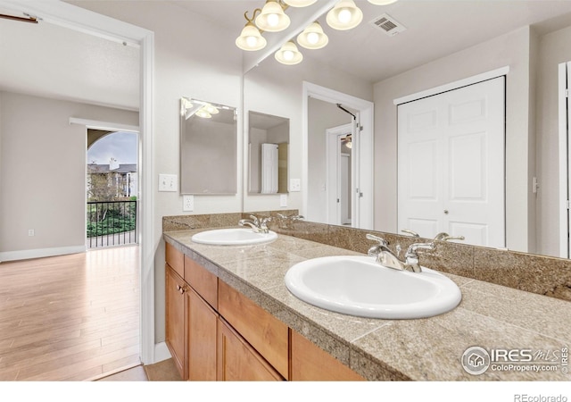 4500 Baseline Rd Unit 3203, Boulder, CO 80303 - full bath with double vanity, visible vents, wood finished floors, and a sink