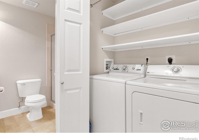 4500 Baseline Rd Unit 3203, Boulder, CO 80303 - laundry room with light tile patterned floors, baseboards, visible vents, washer and clothes dryer, and laundry area