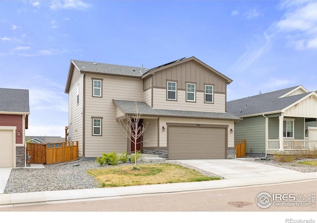 view of front of property with fence, an attached garage, board and batten siding, and concrete driveway