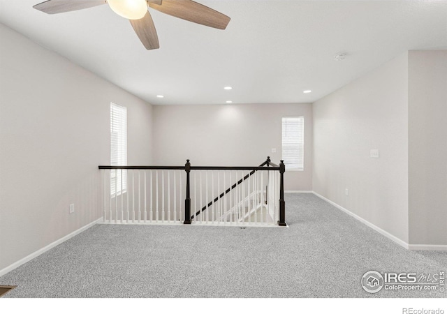 carpeted spare room featuring recessed lighting, baseboards, and ceiling fan