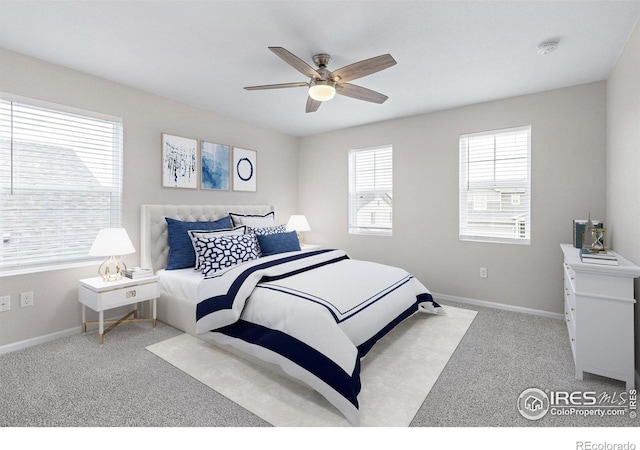 carpeted bedroom with baseboards and a ceiling fan