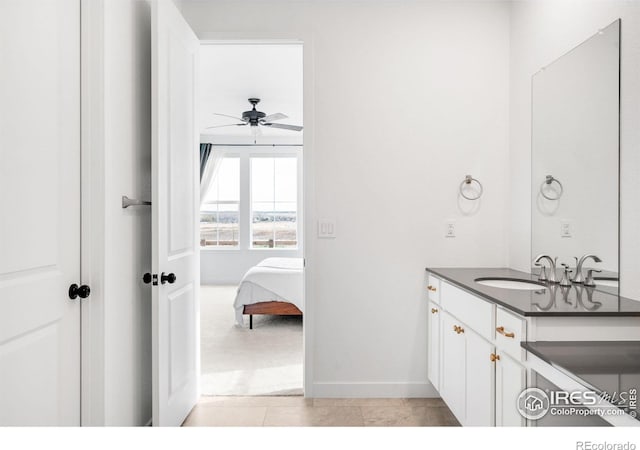 840 Clover Loop, Lafayette, CO 80026 - bathroom featuring ceiling fan, ensuite bath, vanity, tile patterned floors, and baseboards