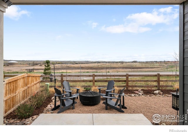 840 Clover Loop, Lafayette, CO 80026 - view of patio / terrace with a fenced backyard, an outdoor fire pit, and a rural view