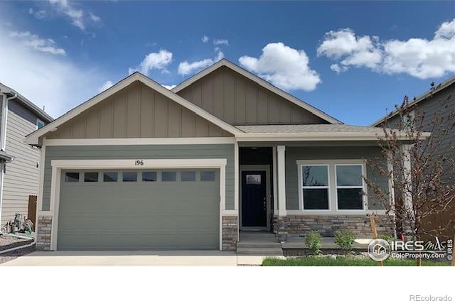 196 Bird Way, Lochbuie, CO 80603 - craftsman inspired home featuring board and batten siding, stone siding, driveway, and a garage
